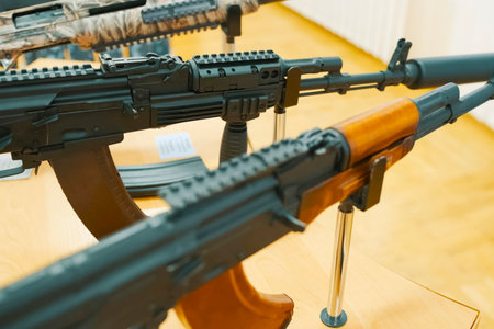 Kalashnikov assault rifle on a display stand at an exhibition.