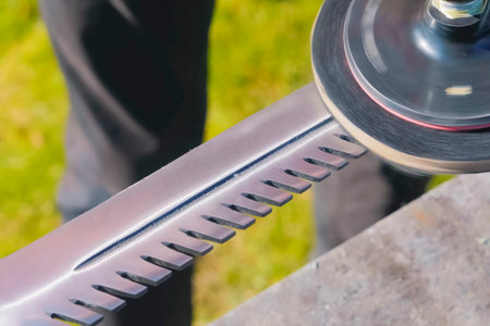 Grinding and polishing the blade of a bayonet knife using a grinder disc