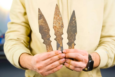 Throwing knife in hand, aiming at target.の写真素材