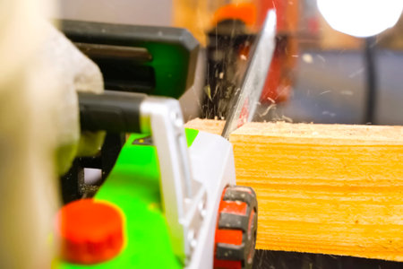 Sawing a wooden beam with a chain electric saw.の写真素材