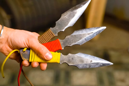 Throwing knife in hand, aiming at target.の写真素材