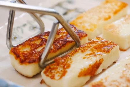 Toasting cheese on a baking sheet, mass production of fried cheese.