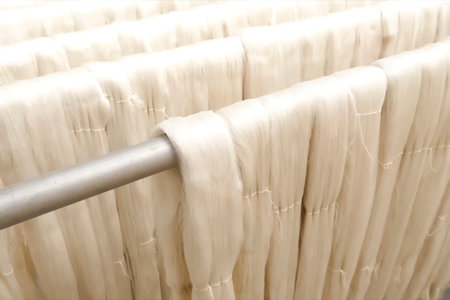 Hanging silk threads on wooden bars.