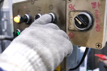 Buttons and switches on the control panel of the machine elements, the hand in a white glove of the worker.の写真素材