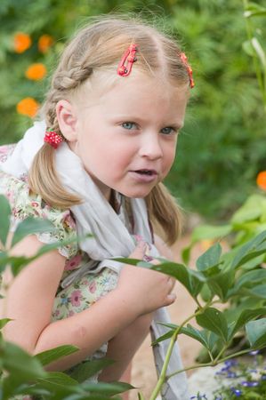 Girl with plaits sits and looks の写真素材