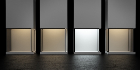 4 glass exhibition stands, one with a white light  3d renderの写真素材