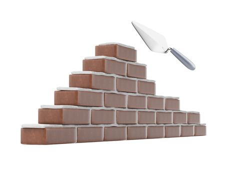 Trowel and brick wall isolated on a white backgroundの写真素材