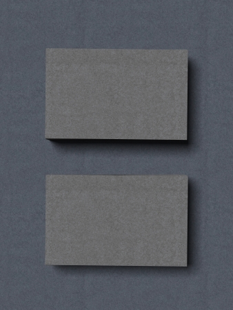 two stacks of grey business cards isolated on a blue background. 3d renderの写真素材