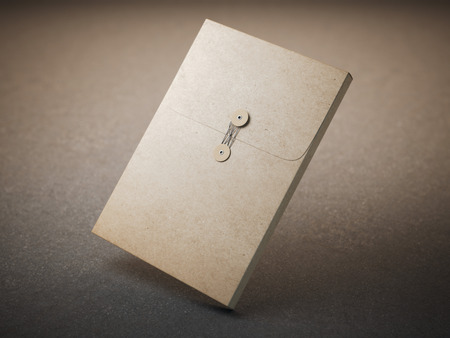 Brown paper folder with tie lock on concreteの写真素材
