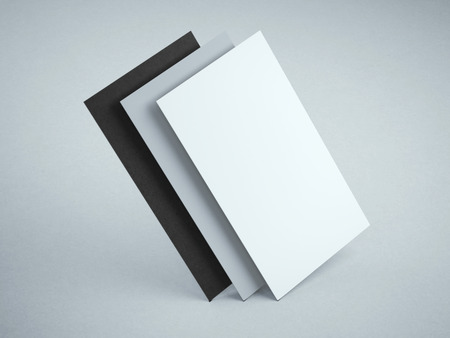 Three blank business cards in gray modern studioの写真素材