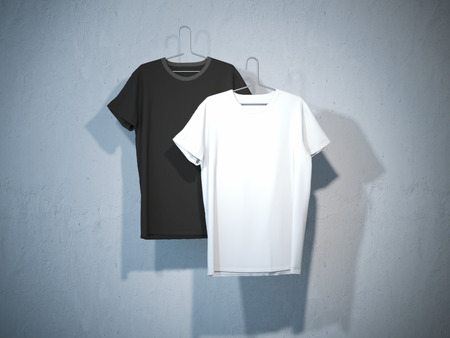 Front sides of two blank t-shirts on metal hangerの写真素材