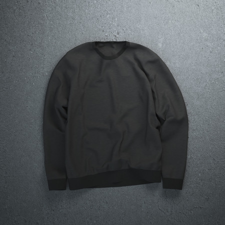 Black sweatshirt on the dark concrete floorの写真素材
