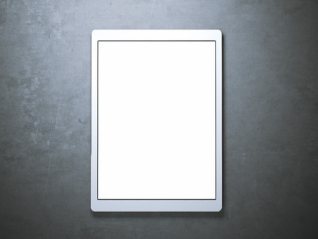Blank white tablet on the concrete floorの写真素材