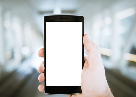 Hand with modern smartphone with blank screenの写真素材