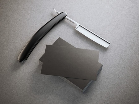 Razor with stack of black business cards