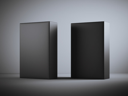 Two blank black boxes in dark studio