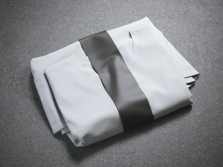 White folded t-shirt with blank label on gray backgroundの写真素材