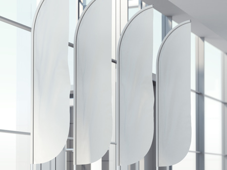 Four vertical wind banners in bright office interior. 3d renderingの写真素材