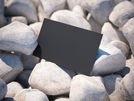 Black business card on white pebble. 3d renderingの写真素材