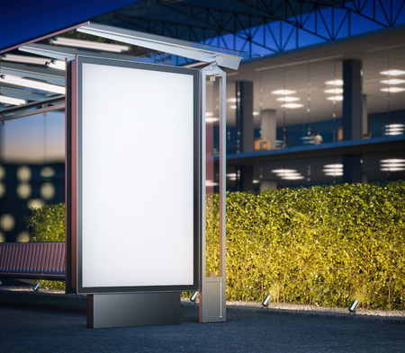 Modern bus stop with blank billboard near office building at night. 3d renderingの写真素材