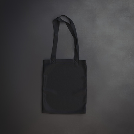 Black cotton textile bag on a dark background. 3d renderingの写真素材