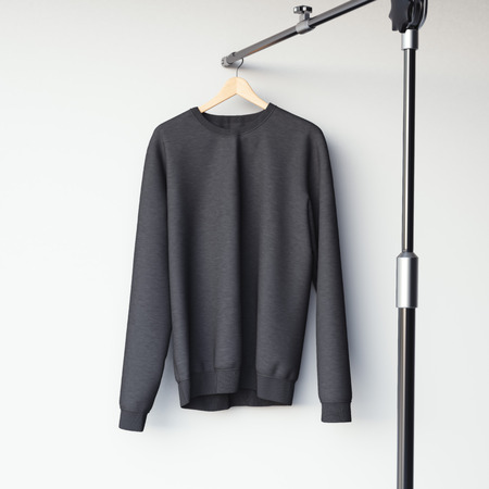 Black blank sweatshirt on modern metal hanger. 3d renderingの写真素材