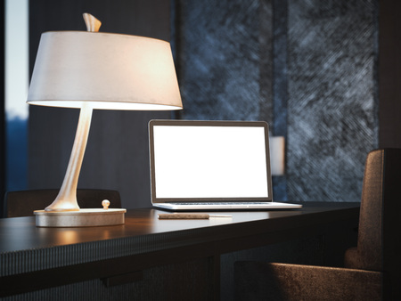 Modern laptop on a classical wood table with lamp. 3d renderingの写真素材