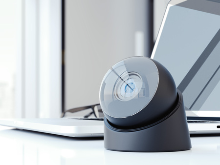 Modern web camera on the office table with laptop. 3d rendering