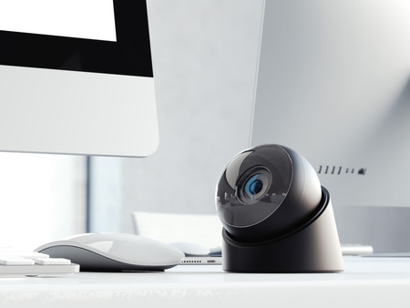 Modern black web camera on the office table with computer. 3d renderingの写真素材