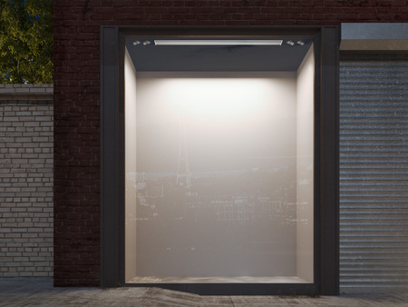Blank shop window in the night street with light on the frame. 3d renderingの写真素材
