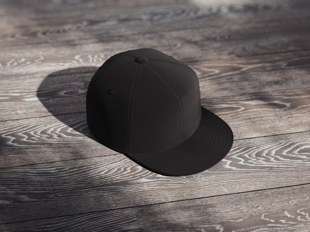 Black realistic cap isolated on dark wooden background, 3d renderingの写真素材