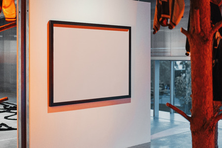 White blank canvas poster on the wall in modern art gallery.