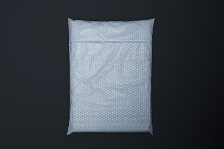 White realistic packet in transparent wrapping on black background. Top view. copy space. Empty space. 3d renderingの写真素材