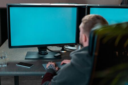 Man working on PC with blank monitors. Modern working place of designer, painter, photographer, freelancer.の写真素材