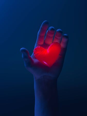 Human Hand Holding Red Luminous Heart. Proposal. Surprise. Giving Love And Affection To Beloved. 3d rendering.の写真素材