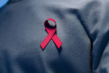 Close Up Of Pink Ribbon On Man Chest. Breast Cancer Awareness Symbol. Breast Cancer Awareness Month. 3d renderingの写真素材