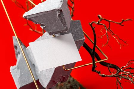 Blank Poster on Abstract Geometric Figures Made From Stone And Branches On Red background. 3d...