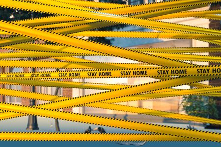 Yellow Tape With Stay Home Warning Sign At Street. Quarantine. Social Distancing. Self Isolation....