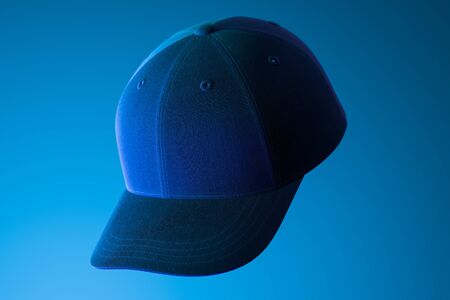 Dark Realistic Blank Cap on Blue Background Illuminated By Neon Light. Copy Space. Empty Space....