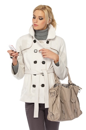 blonde woman with cellphone isolated on whiteの写真素材