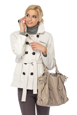 blonde woman with cellphone isolated on whiteの写真素材