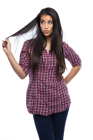 young asian woman playing with her hair in studioの写真素材