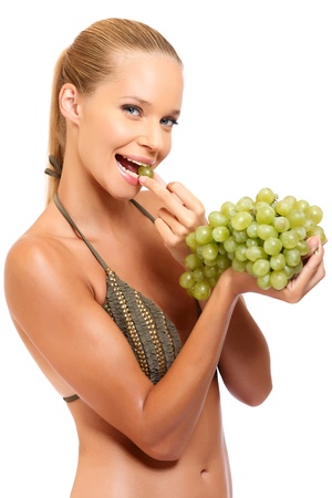 sexy woman eating grapes on white backgroundの写真素材