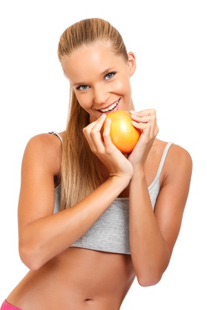 sportry woman with orange isolated on whiteの写真素材