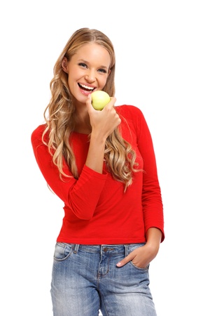pretty blonde woman eating apple on white backgroundの写真素材