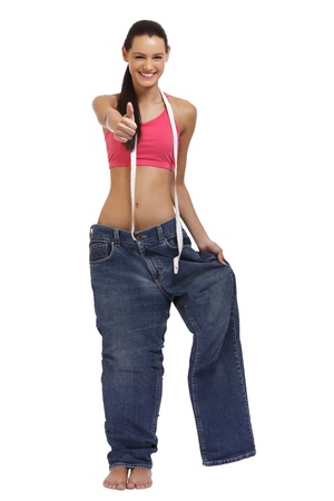 happy young woman posing in a big trousersの写真素材