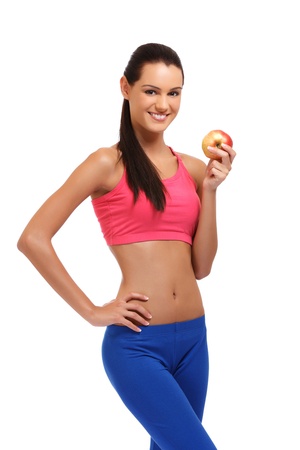young brunette teenager posing with apple on white backgroundの写真素材