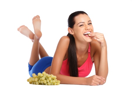 beautiful brunette woman posing with fruit in studioの写真素材