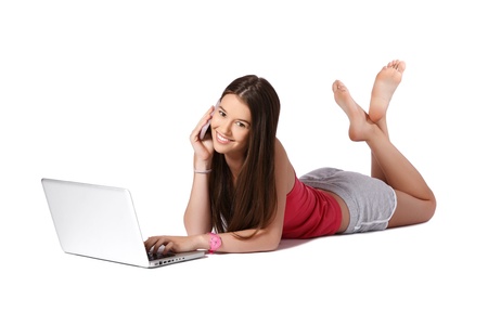 nice young model posing with cellphone and laptop on white backgroundの写真素材