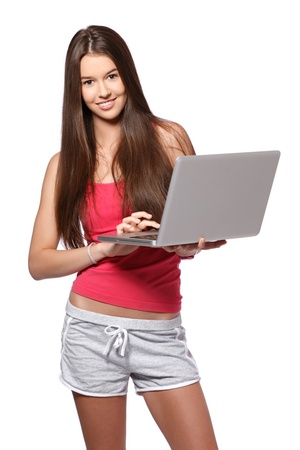 nice brunette girl posing in studio with her laptopの写真素材